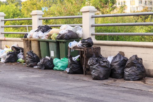 Company vehicle and crew preparing for a commercial waste collection