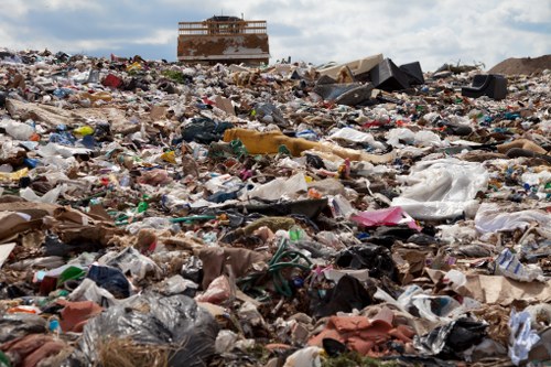 Worker performing risk assessment at a waste handling area